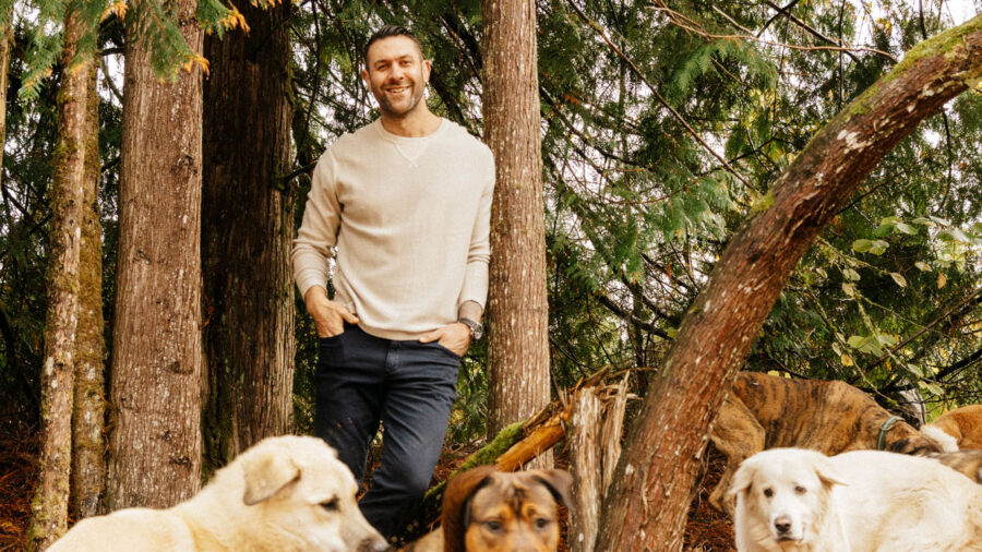 Lee Asher with dogs in the woods
